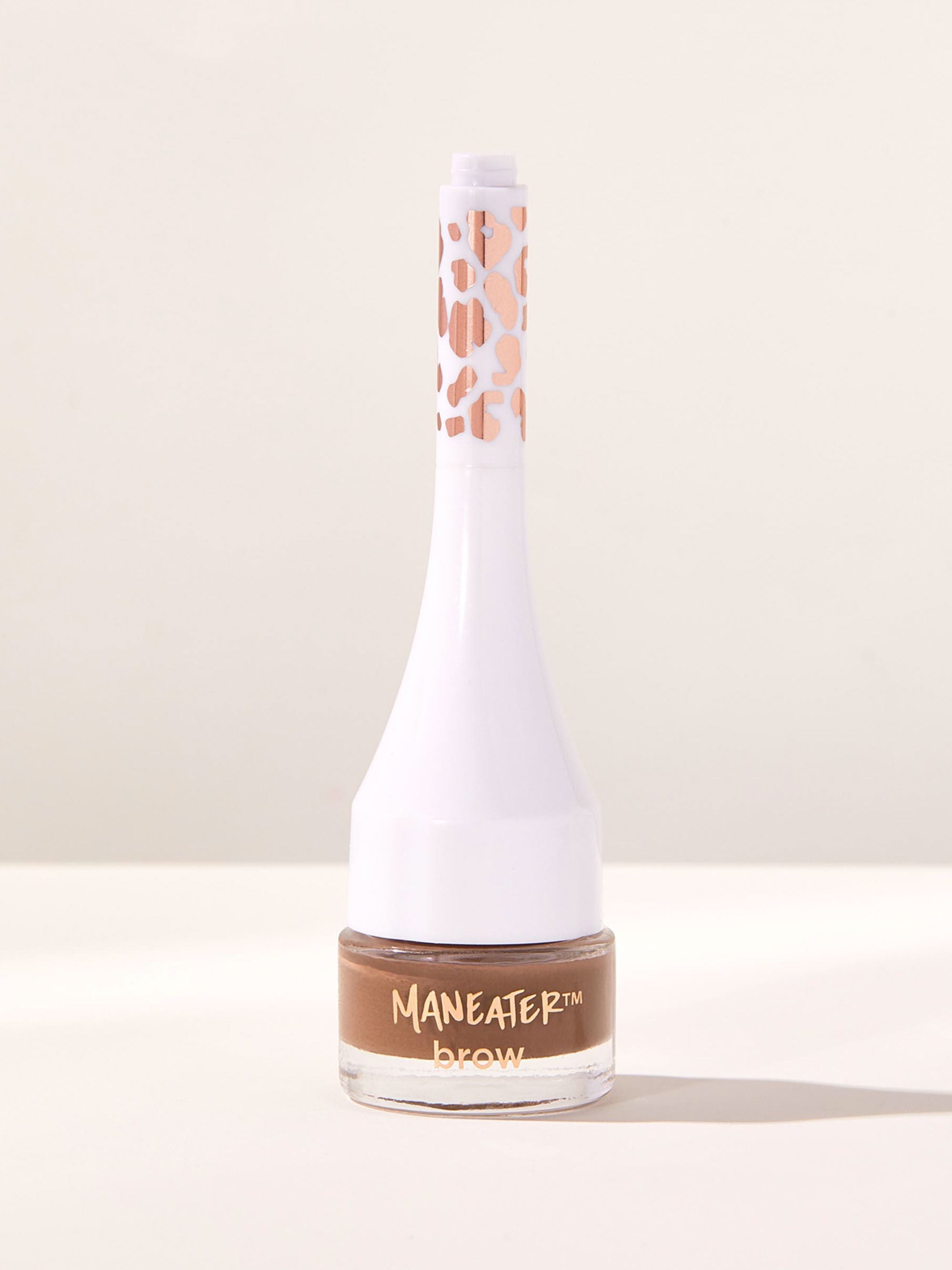 Bottle of Maneater brow product on a light background
