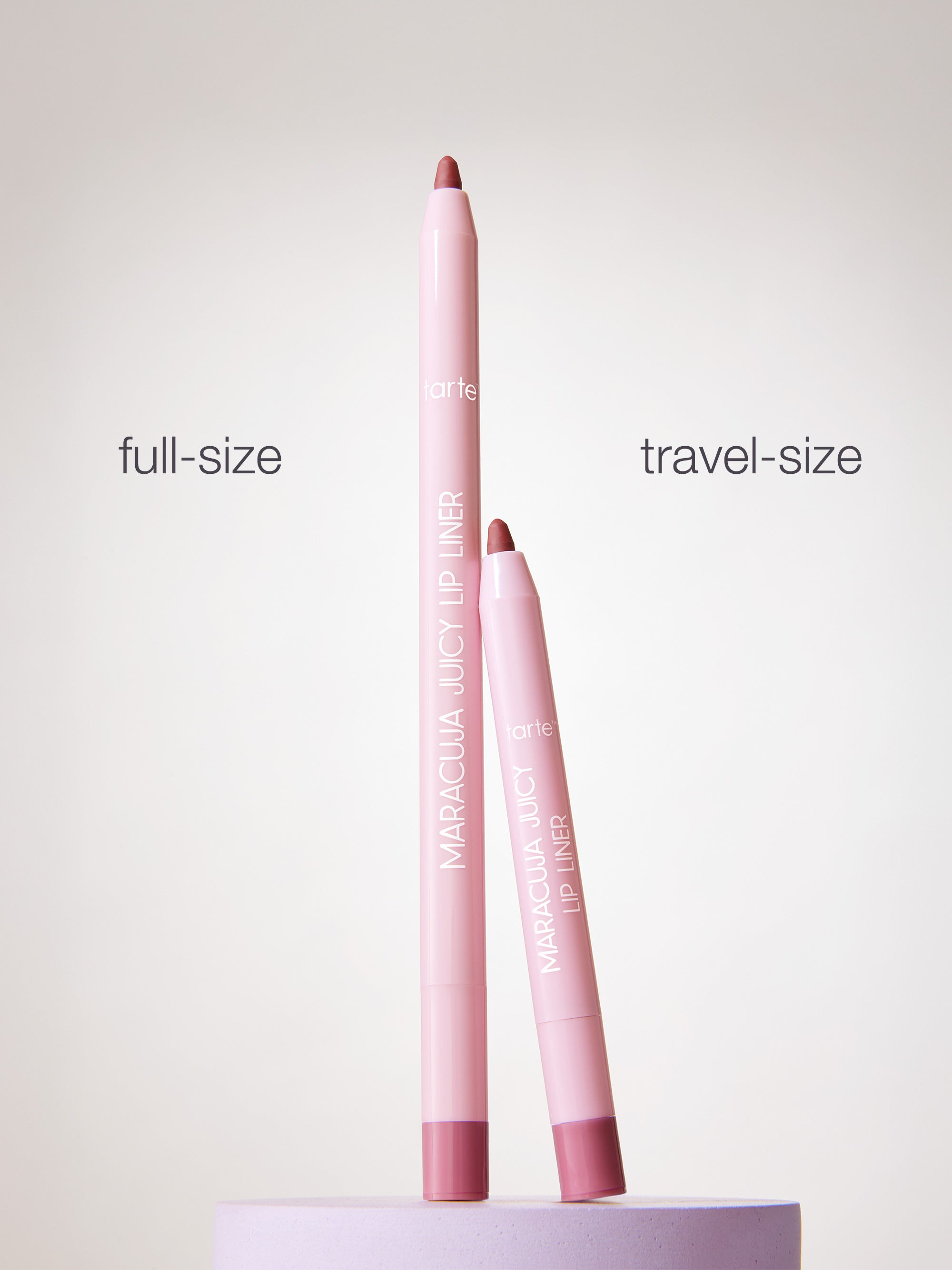 Two pink lip liners, one full-size and one travel-size, on a white background.