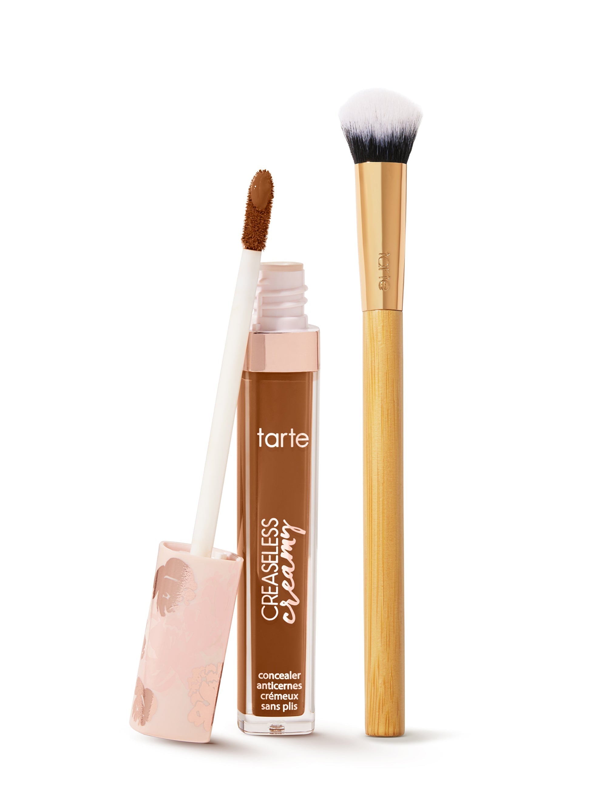 tarte creaseless creamy concealer  with applicator and brush on a white background