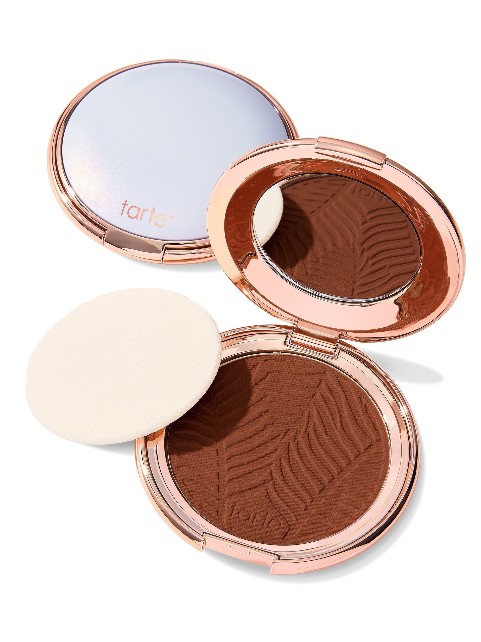 Compact powder with zebra pattern in rose gold case on white background