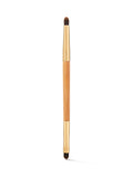 Makeup brush with wooden handle and black bristles on a white background