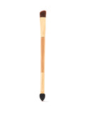 A dual-ended makeup tool with a wooden handle features a firm, angled brush on one end and a tapered sponge tip on the other, set against a plain white background.