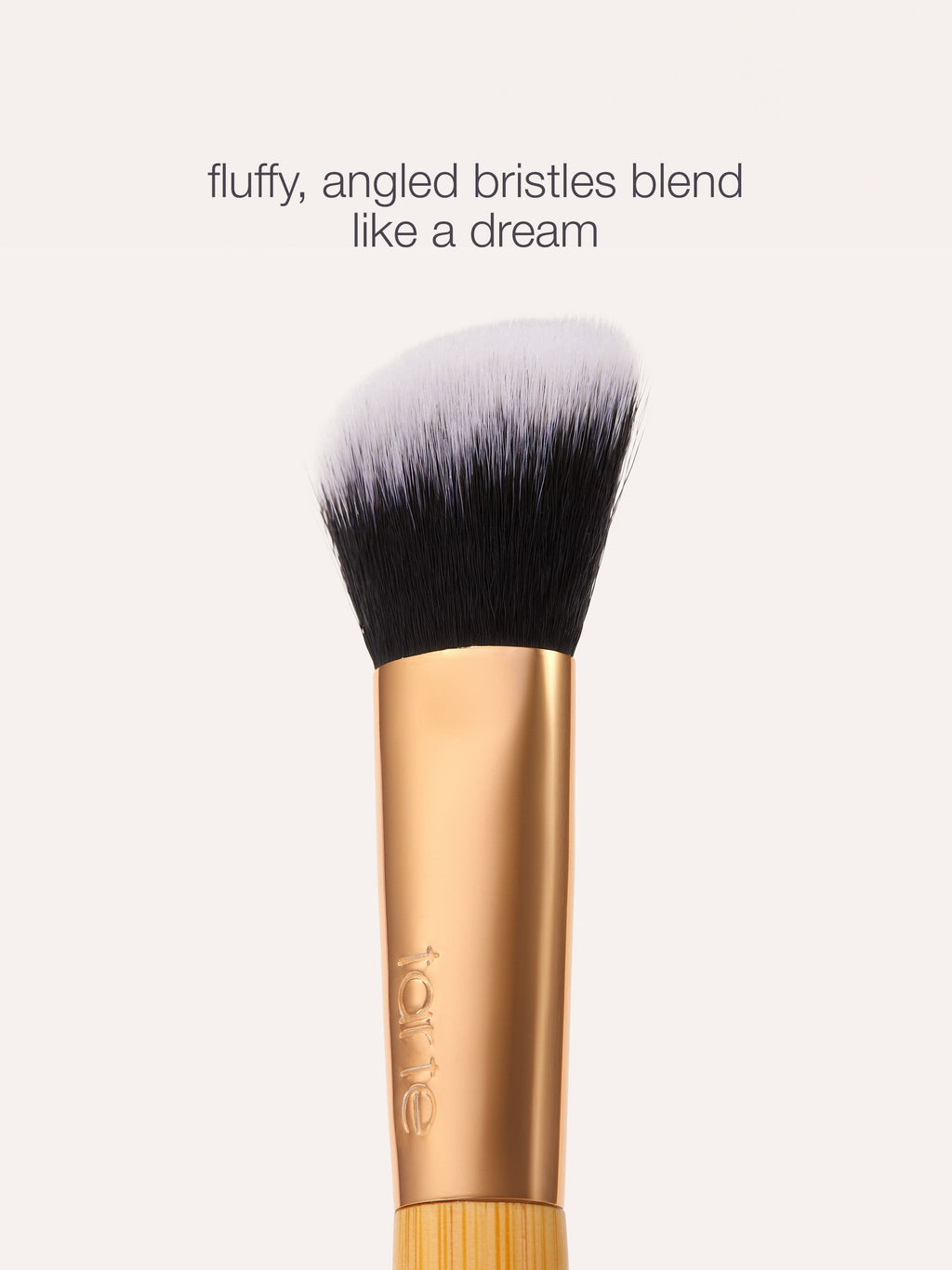 tarte concealer paw brush with fluffy, angled bristles on a white background