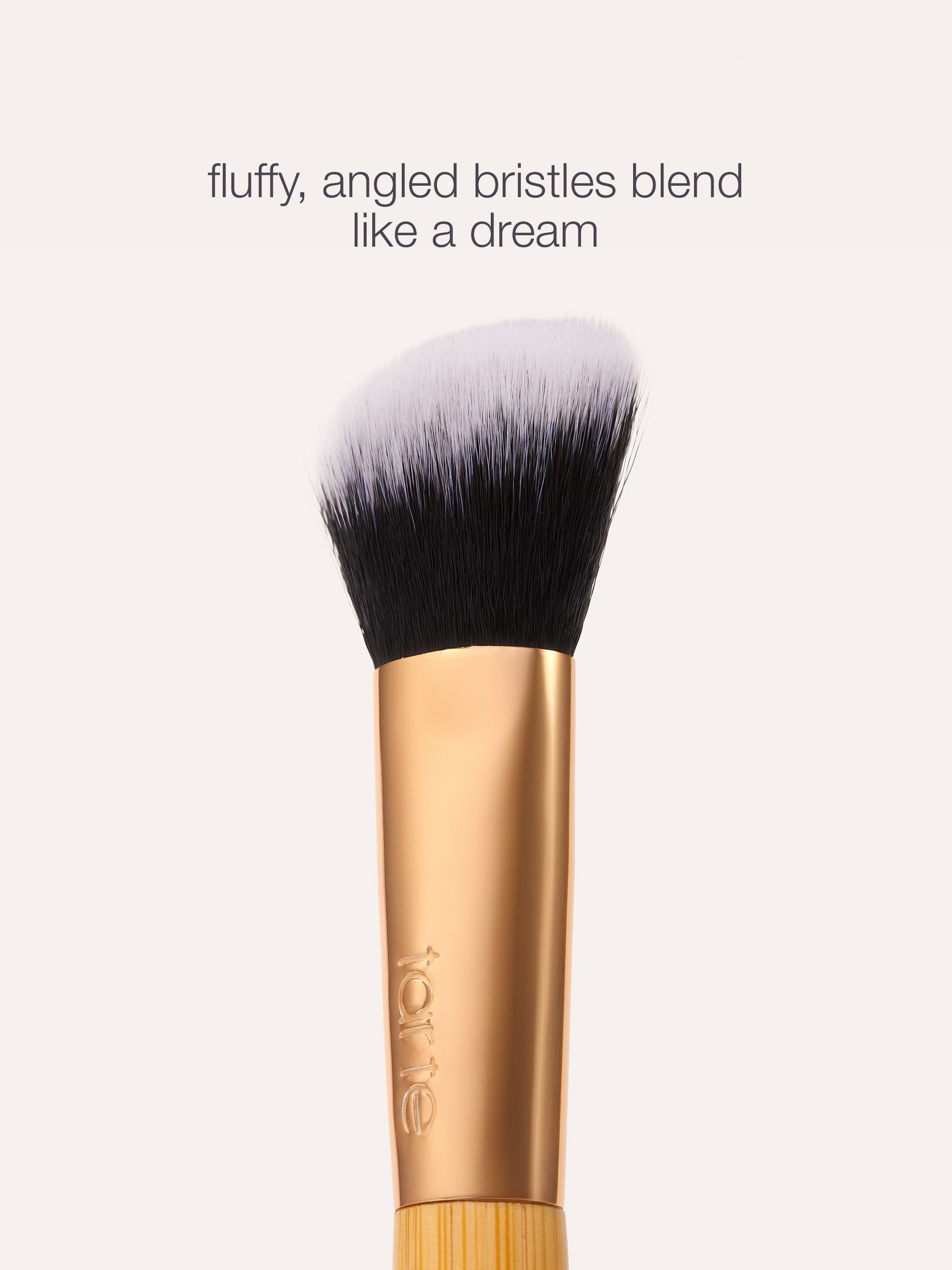 tarte concealer paw brush with fluffy, angled bristles on a white background