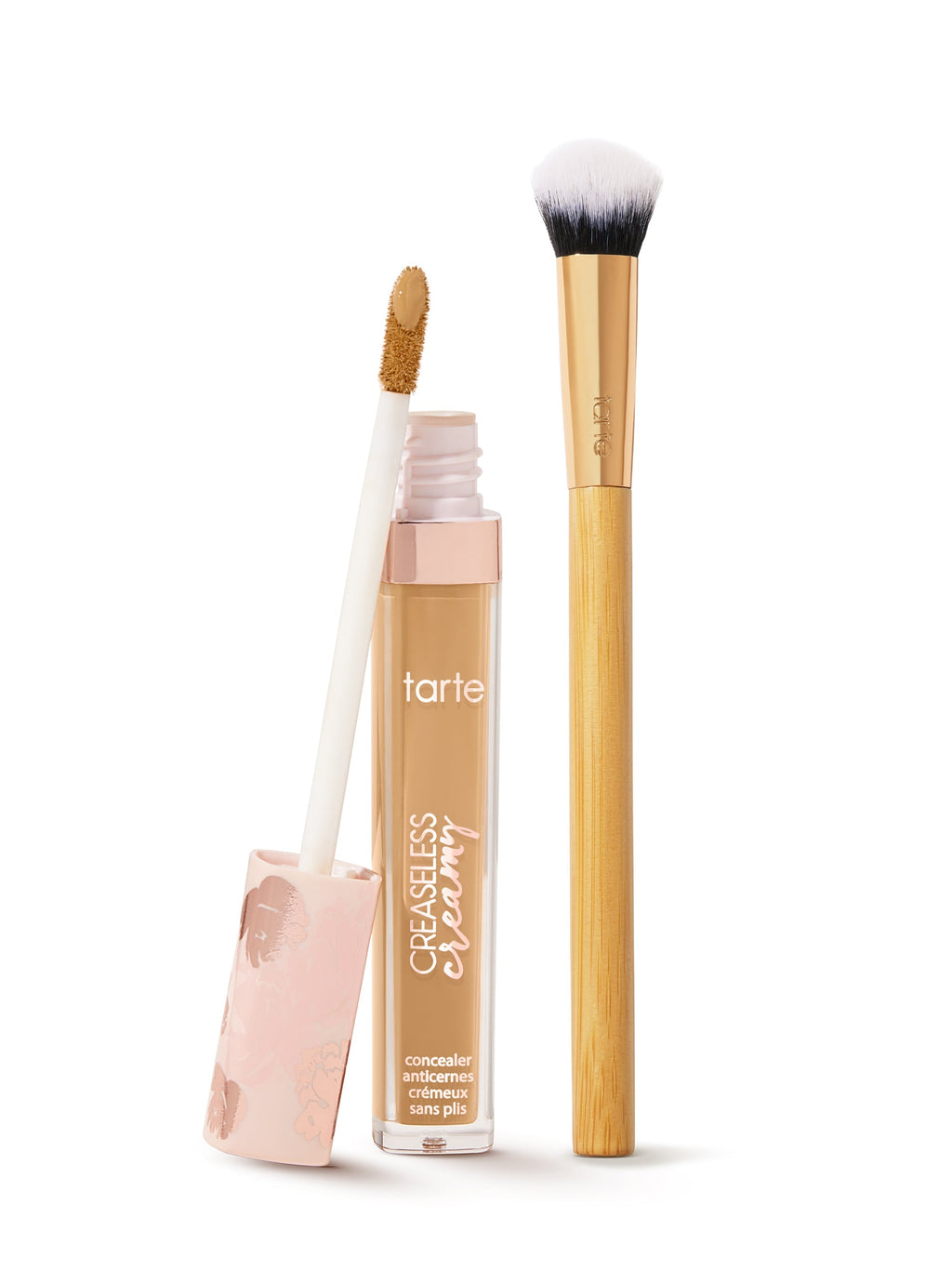 tarte creaseless creamy concealer  with applicator and brush on a white background